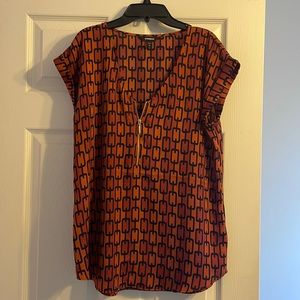Express short sleeve blouse with zipper on the front. Size Med.